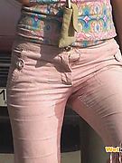 Curly blondie piddling in her sexy pink breeches right in the street