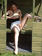 Bare Pussy Upskirts - redhead reading outdoors in short skirt fondles her pussy!