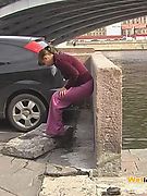 Embarrassed angel peeing in her amazing pants behind a car in public
